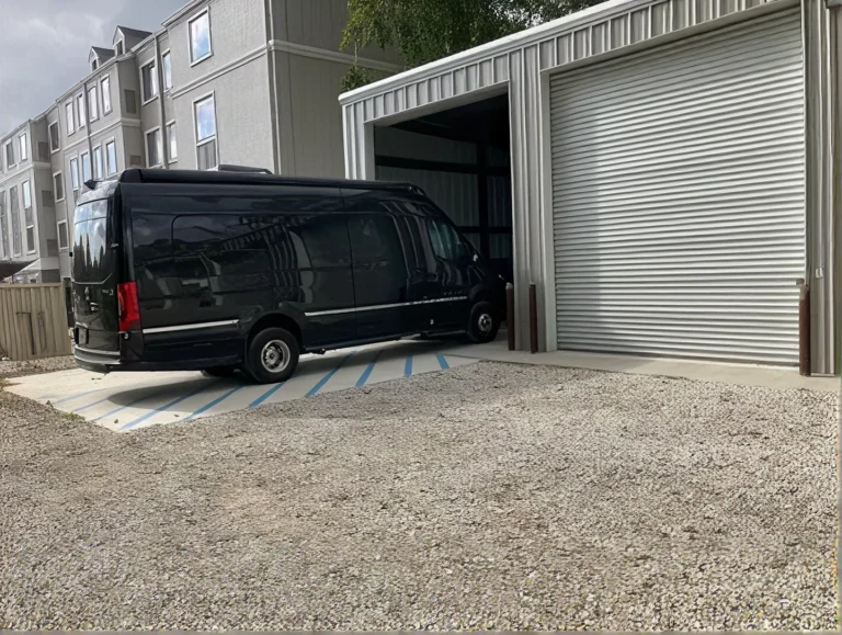 Black van parked in front of an open storage unit at Pinhook Boat & RV Storage